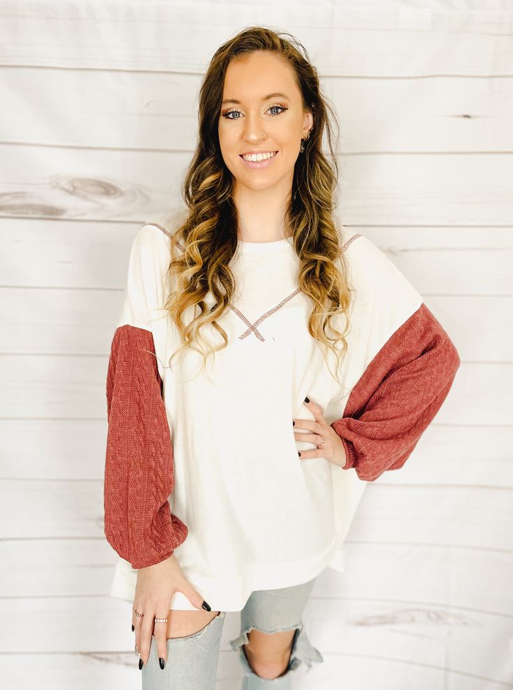 Let's celebrate the start of summer with a top that's just plain gorgeous. A cross between a top, a crewneck pullover, and a sweater, this top is made of the SOFTEST fabric ever and has a fun color-block look with the cable-knit sleeves. You're going to want to wear this every day. The fabric is incredibly lightweight (and oversized) making this the perfect top for summer evenings, whether you're heading out to dinner, to a brewery, or for a post-sunset beach stroll. Plus, this top will be styli Color Block Tops For Fall Layering, Color Block Crew Neck Sweater For Loungewear, Knit Tops With Balloon Sleeves For Fall, Fall Knit Tops With Balloon Sleeves, Fall Balloon Sleeve Knit Tops, Spring Color Block Sweater For Loungewear, Spring Crew Neck Long Sleeve Knit Top, Cream Soft Knit Tops For Layering, Red Sweater For Spring Loungewear