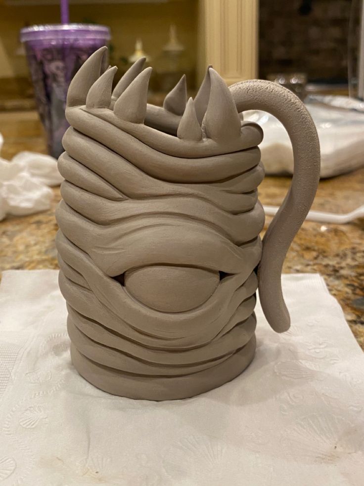 a clay mug sitting on top of a table