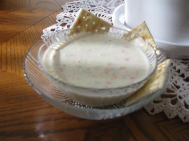 a glass bowl filled with food on top of a doily next to a cup