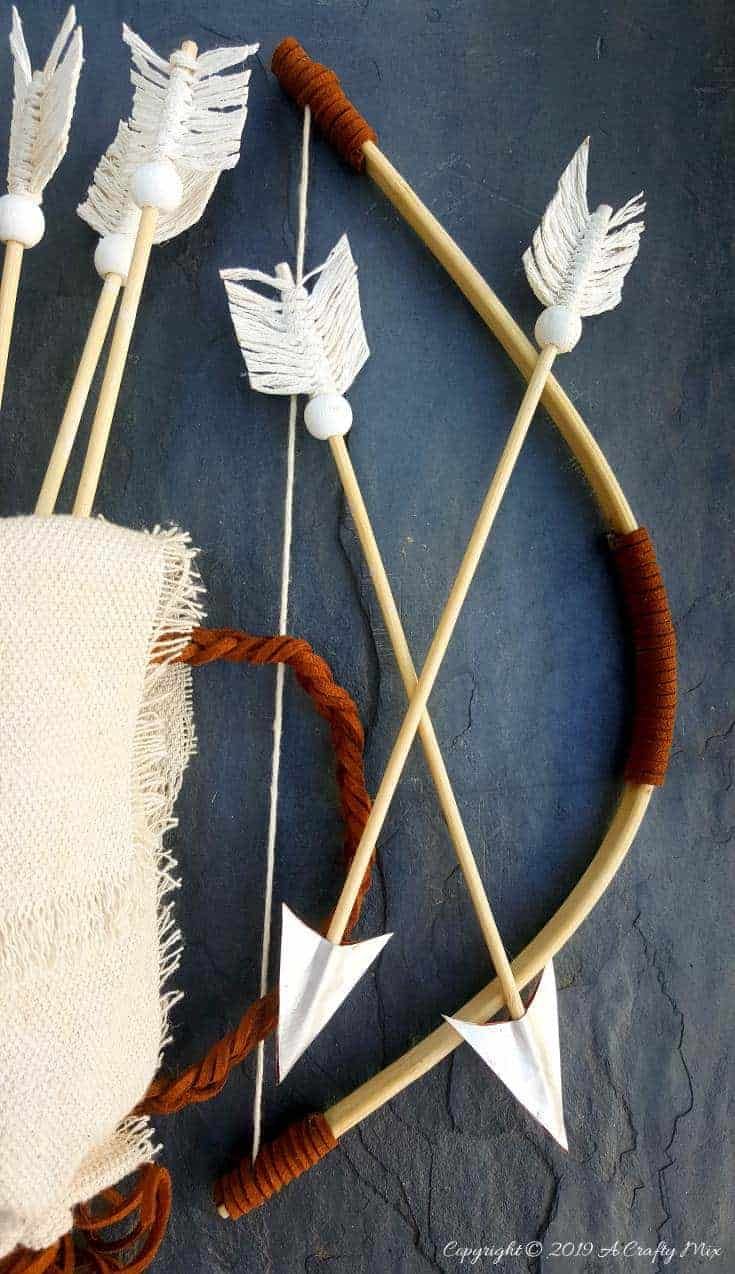 an arrow, bow and arrows made out of yarn