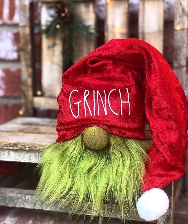 a red and green trolly hat with the word grin on it's forehead