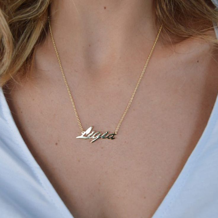 Every stylish woman should have a Custom Nameplate Necklace in their jewelry box. Not only do they look fashionable, but they look gorgeous on their own or layered up. This particular style features a font that is easy to read and that has a beautiful flow to it. The colors are all neutral metallics, which makes them very versatile. All of our name necklaces have a polished surface so that they gleam beautifully in the light. If you are on the hunt for a thoughtful gift for a loved one, this wou Bar Necklaces, Name Necklace Silver, Name Necklaces, Nameplate Necklace, Infinity Necklace, Custom Name Necklace, Initial Pendant, Recycled Sterling Silver, Gold Plated Silver