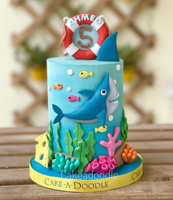 a birthday cake with an ocean theme on the top and under it's age