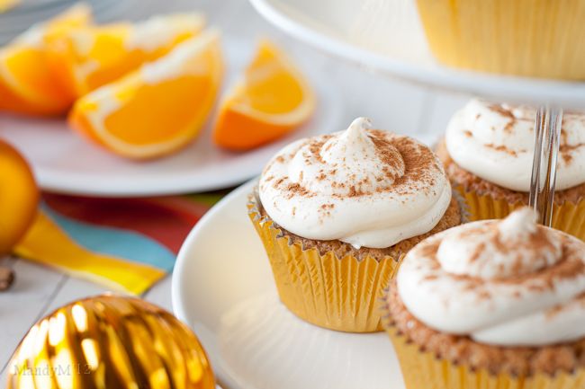 cupcakes with white frosting and orange slices