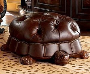 a brown turtle ottoman sitting on top of a rug