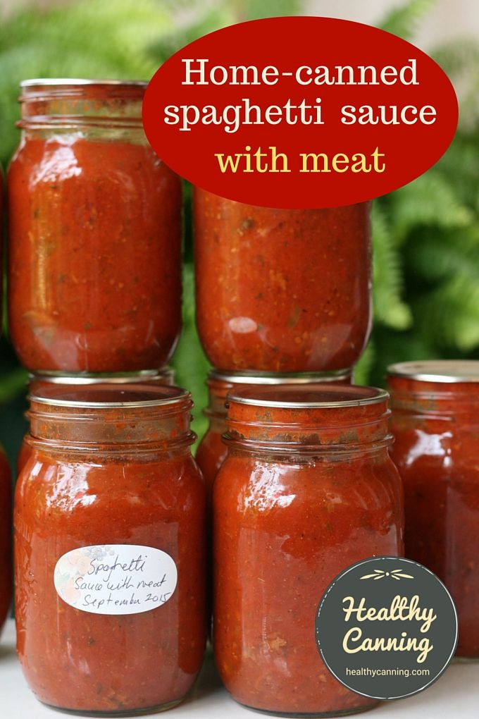 several jars filled with red sauce sitting on top of a table