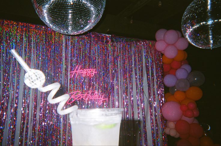 a birthday decoration with balloons and streamers