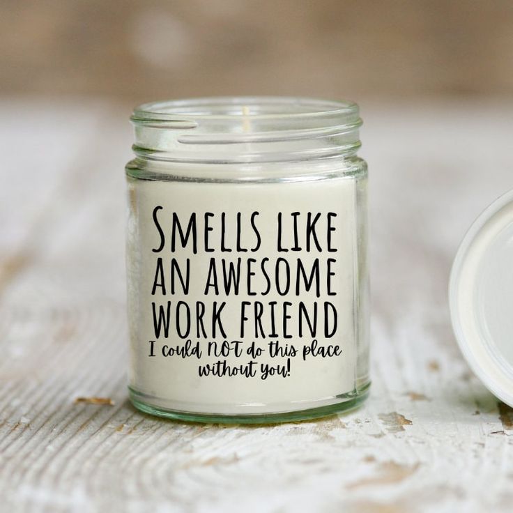 a jar with some writing on it sitting next to a small white container that says smells like an awesome work friend i can't wait for this place without you