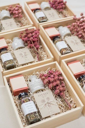 six wooden boxes filled with different types of condiments and flowers on top of a table