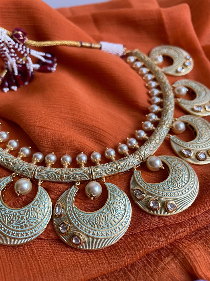 Gorgeous hasli style Rajasthani meenakari choker with kundan stones and matching earrings and tikka is the classiest piece of jewelry! This set is beautifully hand crafted and is very lightweight and versatile to wear! Festive Meenakari Metal Jewelry Sets, Navratri Meenakari Jewelry, Temple Jewelry Sets With Meenakari, Traditional Meenakari Chandbali Sets, Festive Kundan Necklace With Meenakari, Kundan Meenakari Chandbali Necklaces, Festive Round Kundan Necklace With Meenakari, Kundan Temple Necklace For Eid, Meenakari Chandbali Jewelry For Eid