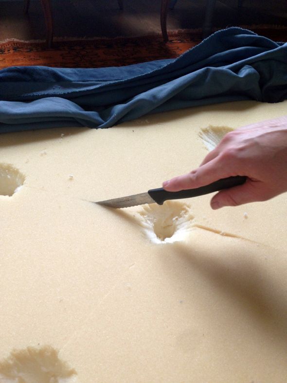 a person is cutting something with a pair of scissors on a piece of paper that has holes in it