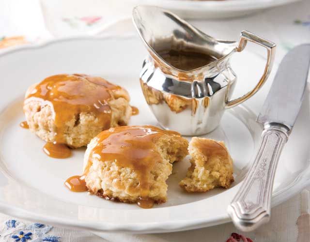 two biscuits covered in caramel sauce on a plate