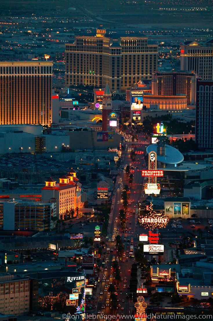 an aerial view of las vegas at night with the strip lights lit up in the background