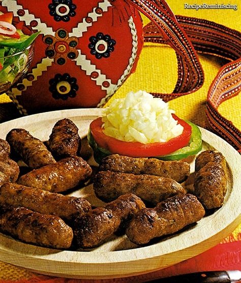 a plate with sausages, mashed potatoes and vegetables on it next to a bag of potato salad