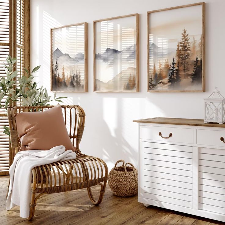 a room with white furniture and paintings on the wall, including a wicker chair