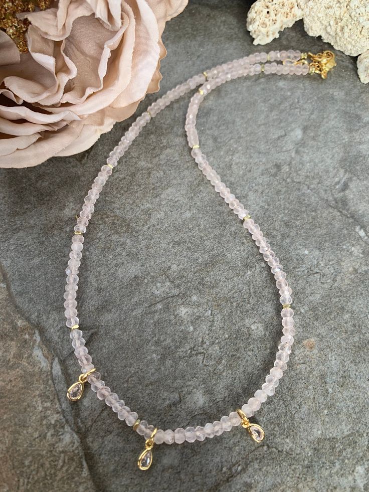 Super pretty gemstone necklace ...crafted with lovely light pink Rose Quartz beads accented with African Brass heishi and pretty little Quartz accents. This stunner measures 16 inches in length with a gold tone extender chain . Delicate Single Strand Pink Necklace, Delicate Pink Single Strand Necklace, Elegant Pink Necklace With Tiny Beads, Dainty Pink Beaded Crystal Necklaces, Dainty Pink Necklace With Gemstone Beads, Dainty Pink Beaded Crystal Necklace, Delicate Pink Gemstone Bead Necklaces, Delicate Pink Gemstone Beaded Necklaces, Pink Delicate Necklace With Gemstone Beads