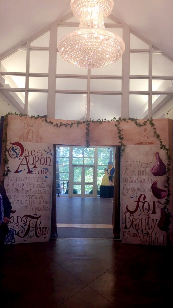 the inside of a building decorated with words and lights hanging from it's ceiling