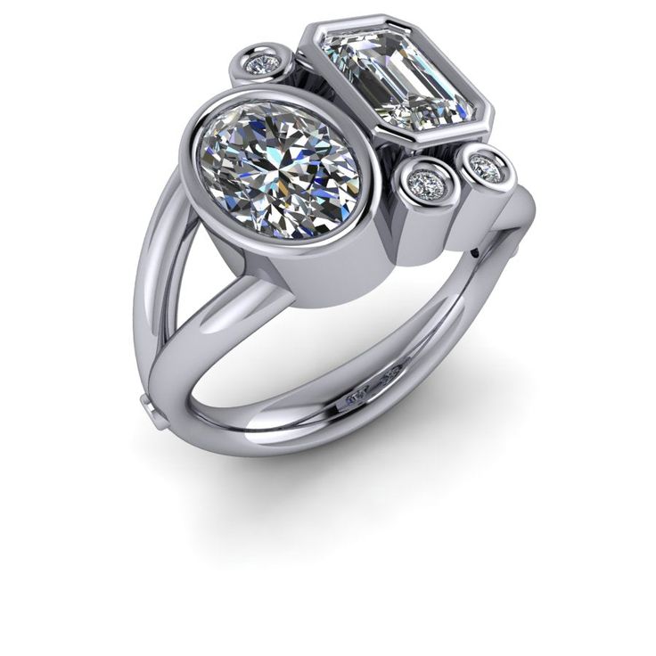 a white gold ring with two diamonds on the top and side stones in the middle