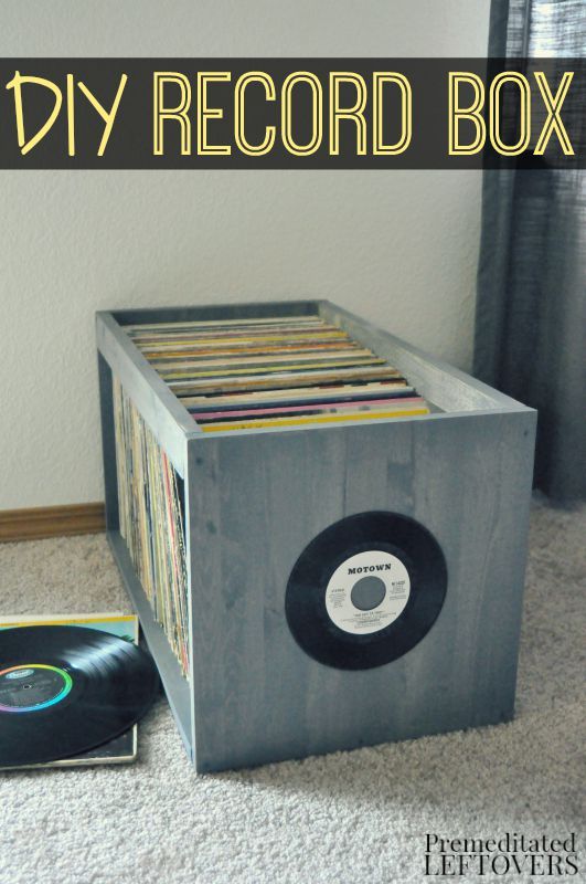 an old record box is sitting on the floor next to a cd case with records in it