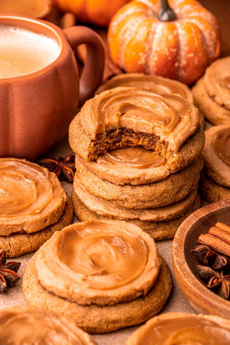 cookies with frosting and cinnamon are arranged on a table