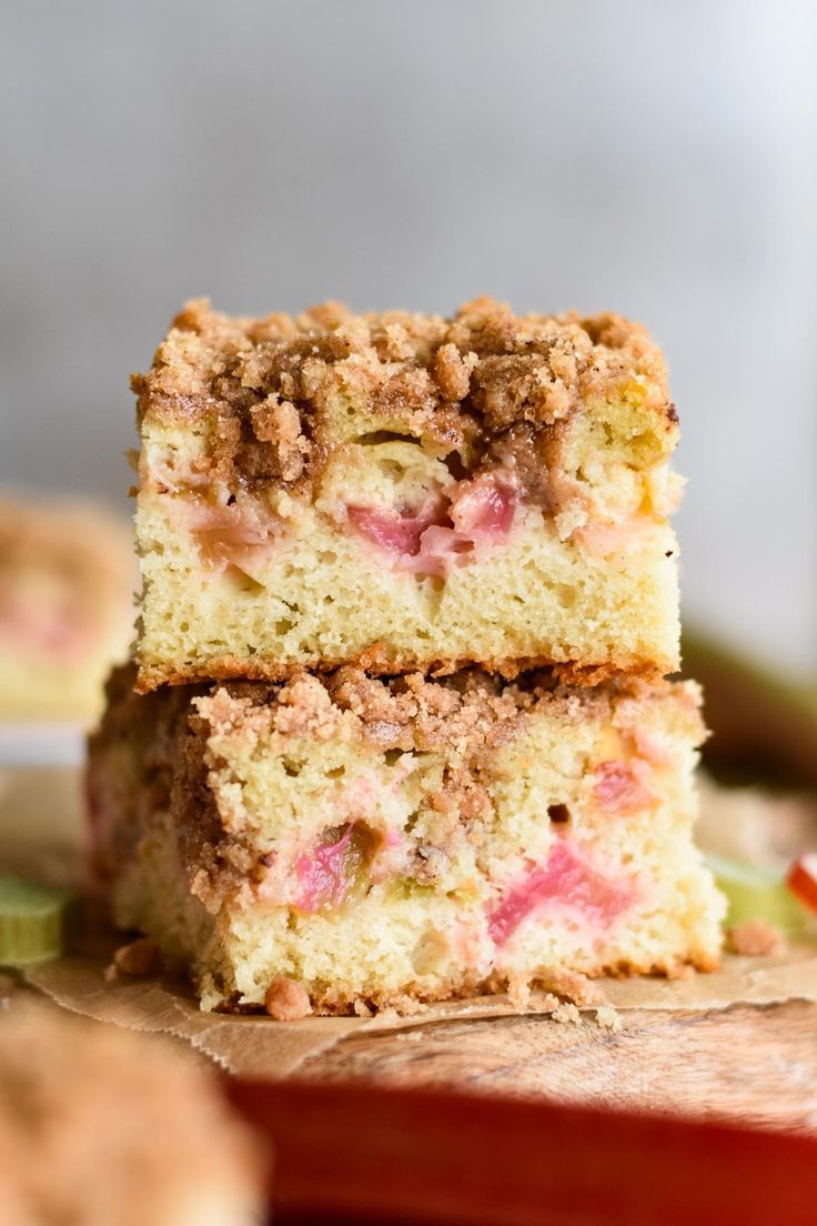 three pieces of cake sitting on top of a cutting board