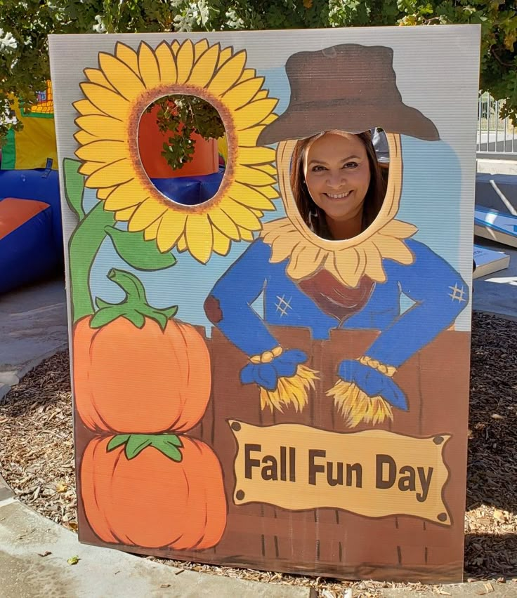 a child's fall fun day sign with sunflowers and scarecrow