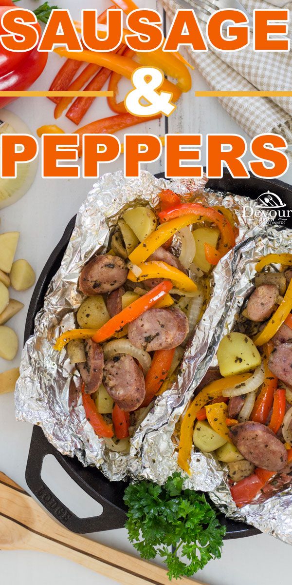 sausage and peppers in foil on top of a pan with parsley next to it