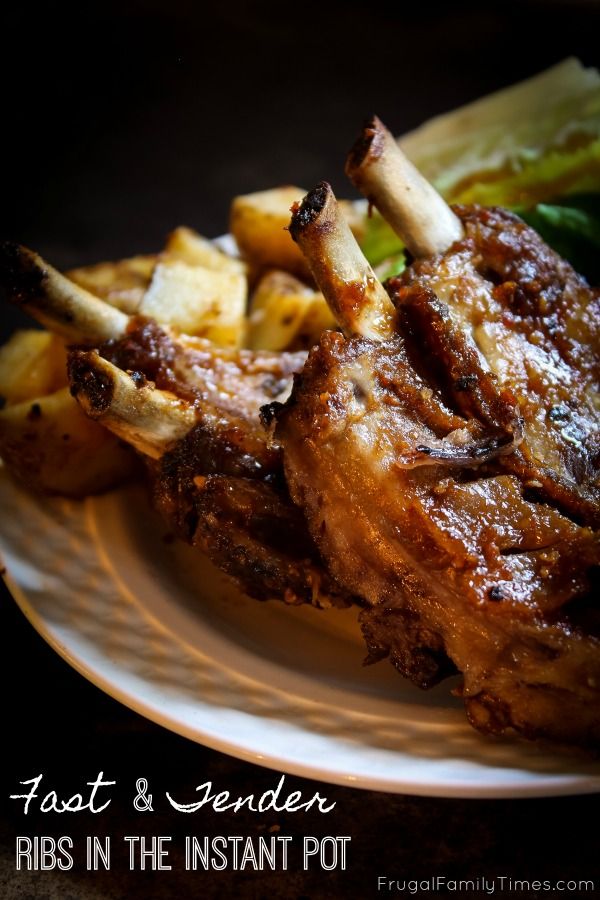 a white plate topped with meat and potatoes