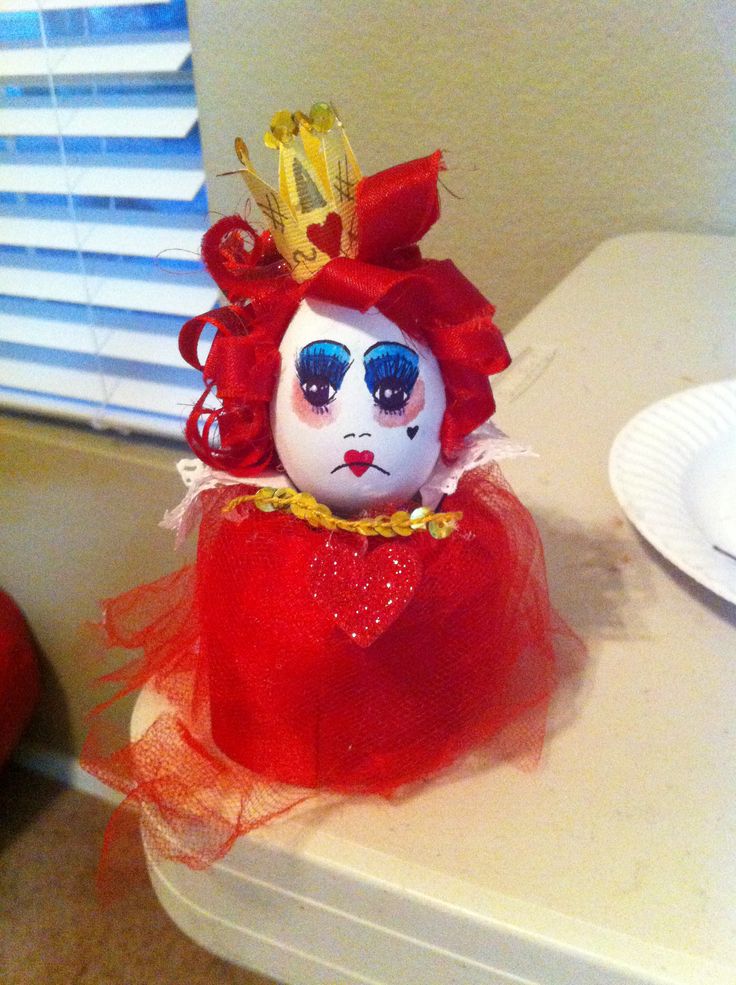 a doll with blue eyes and red hair sitting on top of a table