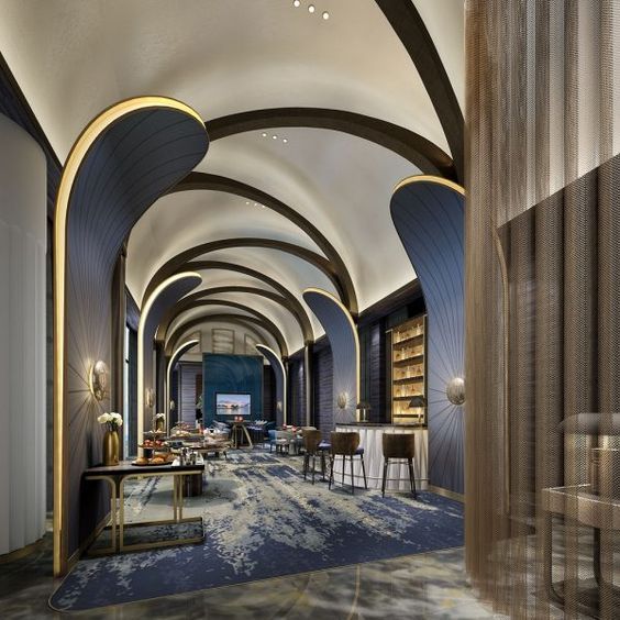 the interior of a modern hotel lobby with high ceilings and curved arches on either side