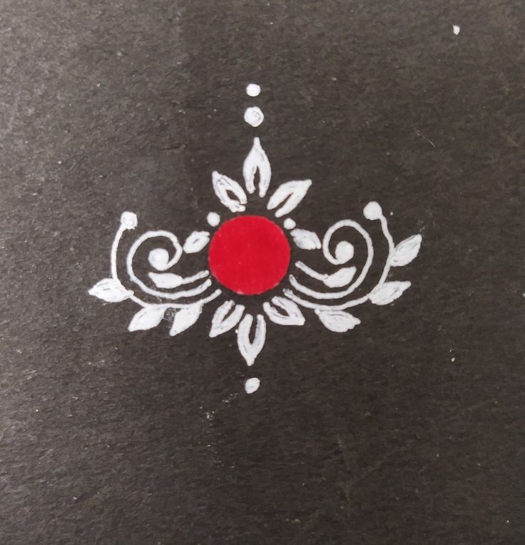 a black surface with white designs and a red circle in the center on top of it