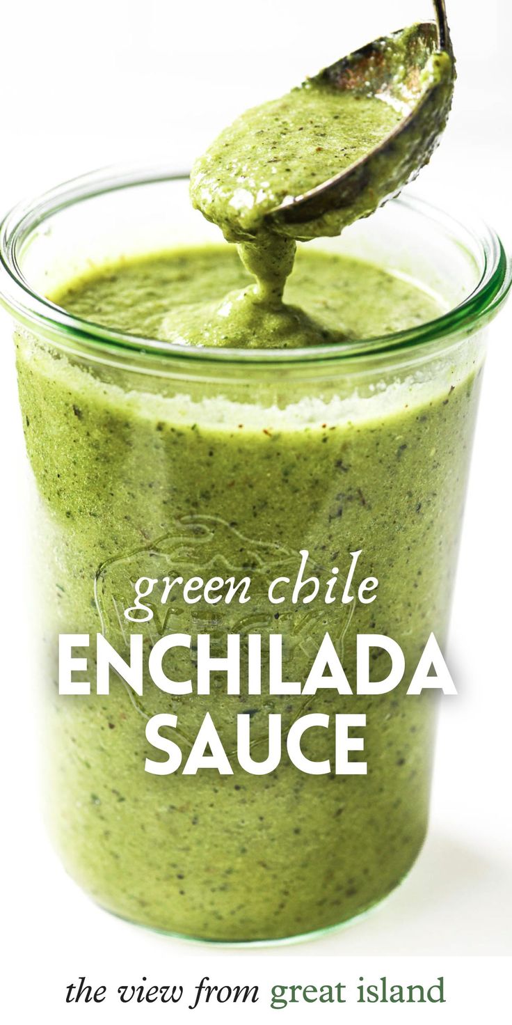 green chile enchilada sauce in a glass jar with a spoon sticking out