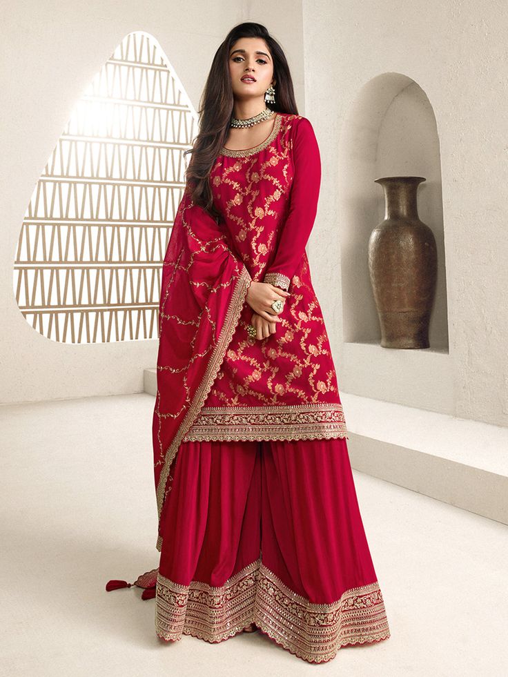 Jacquard chinon sharara suit in Red colour 66216 Jacquard Chinon Fabric with Jaal Work & Embroidered Scalloped Border Work in Daman and Sleeves on Kurta. Paired with Chinon Fabric Heavy Embroidered Scalloped Border Work in Sharara and Chinon Fabric Buttis Work on Dupatta with Four Sided Scalloped Border. Unstitched suit material till size 42 inches.Desc:  Style : Pakistani Sharara suit Color : red Fabric : Jacquard chinon silk Dupatta :Bemberg chiffon Work : Buttis Wash Care : Dry clean Sleeve Style : Full Sleeve Long Sleeves : Done only in Custom Stitch Sleeves Lining : Done only in Custom Stitch Bust Size : 32 to 42 Inches Occasion : Temple Wear   Social Gathering   Pongal   Gudi Padwa   Onam   Ugadi Navaratri Durga pooja Diwali. With Express Free Shipping and Custom Stitching, Buy I Pakistani Sharara Suit, Pakistani Sharara, Sangeet Outfit, Pakistani Suit, Sharara Suit, Palazzo Set, Party Wear Lehenga, Party Kleidung, Festive Wear