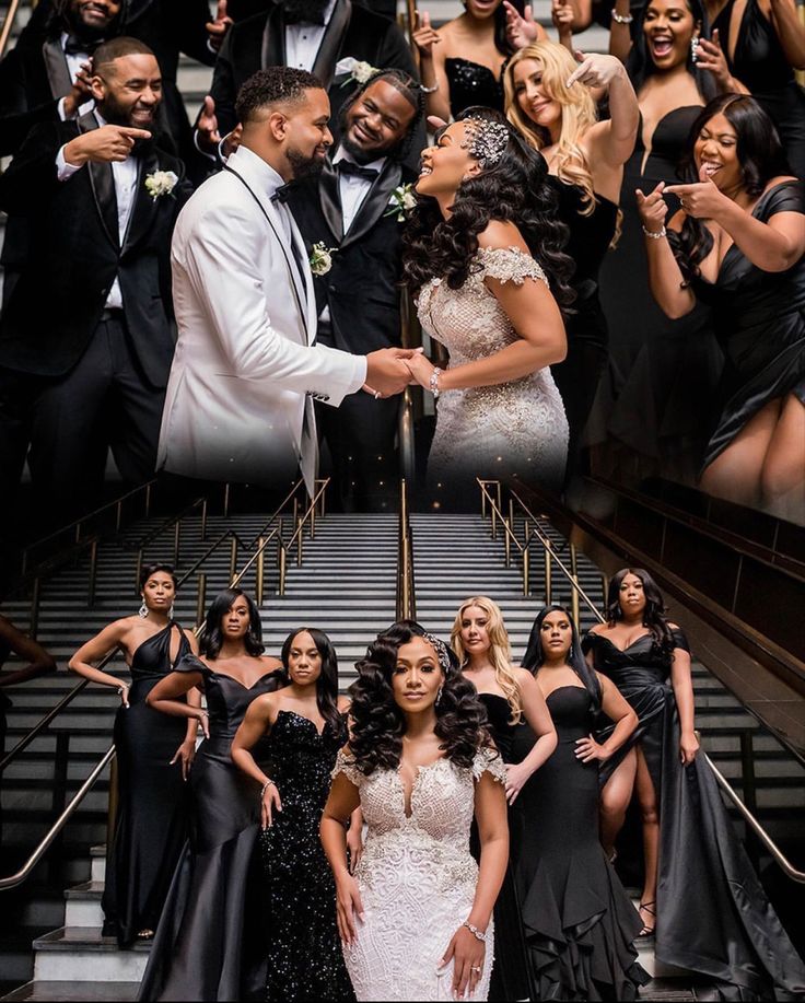 a group of people in formal wear posing for a photo on the stairs with one woman shaking another's hand