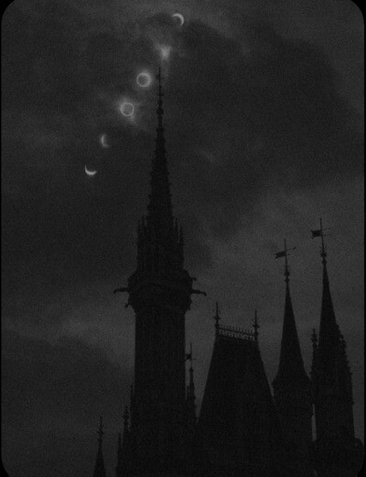 the moon is seen in front of an old building with steeples and spires