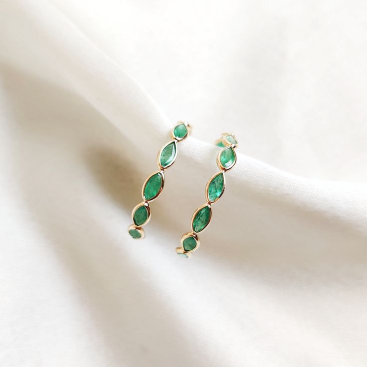 These stunning hoop earrings are set in 14k Solid Yellow Gold with Natural Emerald with utmost precision. It is an unique and dainty gemstone earring pair for nearly every occasion and is completely hassle-free jewelry. 🔷ABOUT GEMSTONE:  Emerald is often associated with love and romantic relationships. It is believed to promote love, loyalty, and unity, making it a popular choice for engagement and anniversary jewelry. Emerald is often associated with abundance and financial success. It is beli Elegant Emerald Huggie Hoop Earrings, Elegant Small Hoop Emerald Earrings, Elegant Small Hoop Emerald Jewelry, Fine Jewelry Marquise Hoop Earrings For Anniversary, Fine Jewelry Bezel Set Hoop Earrings As Gift, Fine Jewelry Hoop Earrings With May Birthstone, Fine Jewelry May Birthstone Hoop Earrings, Hoop Earrings For Anniversary With May Birthstone, Anniversary Hoop Earrings With May Birthstone