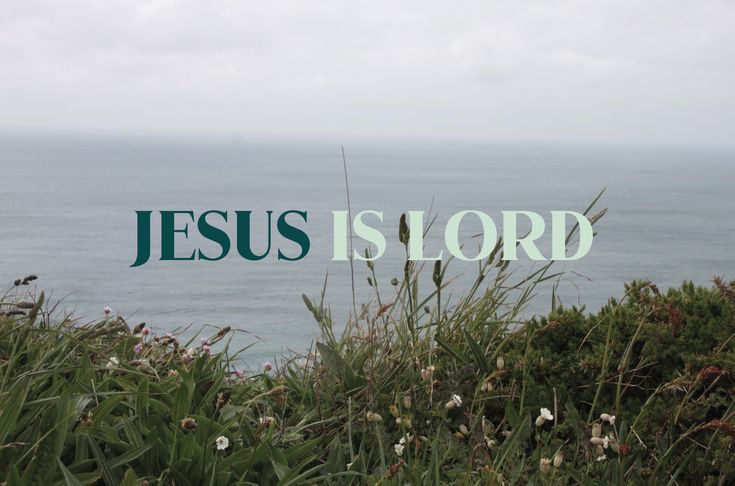 the word jesus is lord written in green over an ocean view