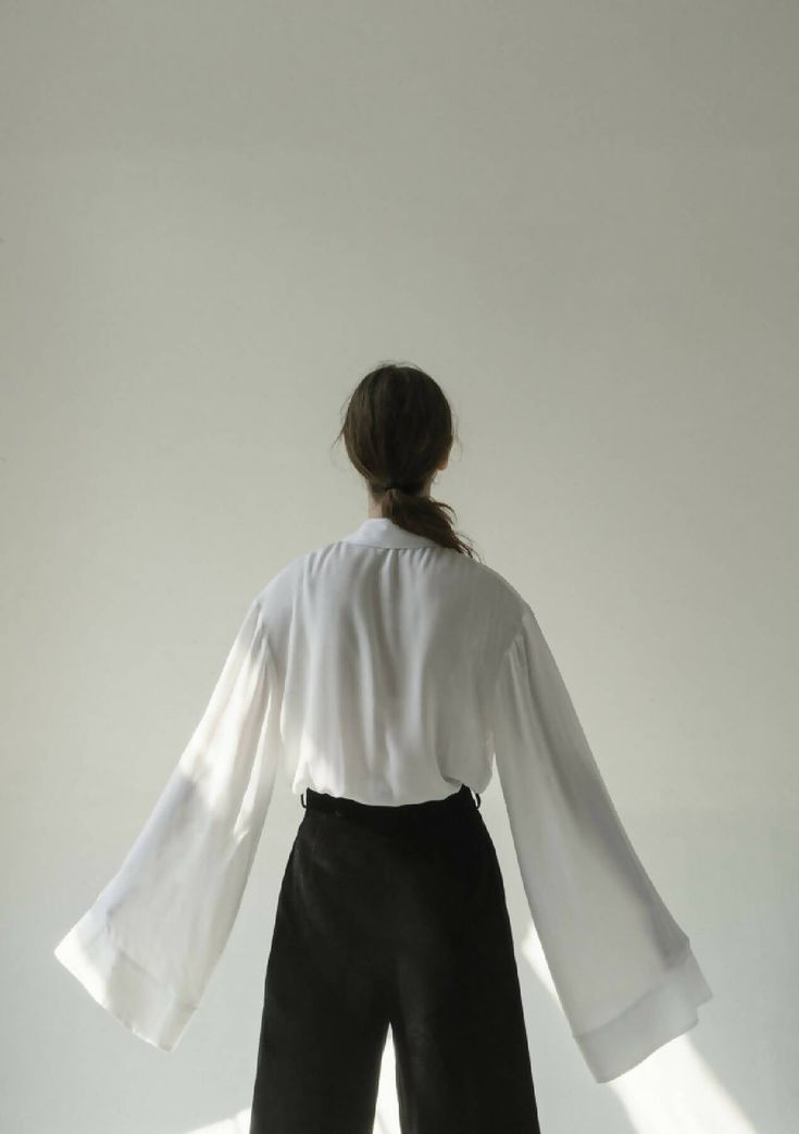 Get lost in the white viscose shirt, found in a limbo between blouse and light outwear. Presented in a soft fluid viscose, the wide barrel cuffs are designed to be worn long. Combines a strong architectural pointed collar and pleated front panel with a soft membrain and hidden buttons.Composition 100% viscoseWash carefully by handHandmade in Ukraine by women artisans for womenK M by L A N G E is a creative design studio based between Barcelona and KyivAll items are crafted out of quality materia Creative Design Studio, Shirt Cuff, Sewing Design, Wide Cuff, Women Artisans, Kiev, Shirt Collar, The White, Creative Design