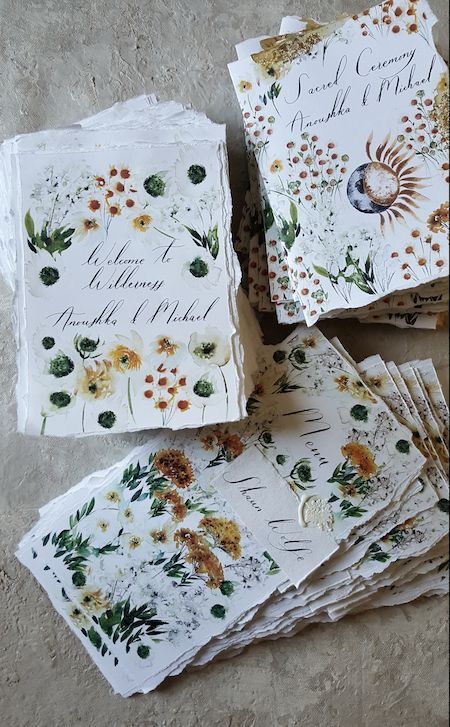 several cards with flowers on them sitting next to each other