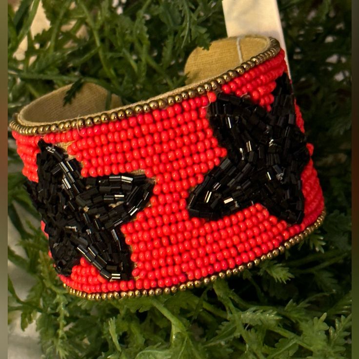 Red/Black Star Seed Bead Game Day Cuff Bracelet Red Beaded Bracelets With Black Beads For Festival, Red Star-shaped Beaded Jewelry, Festive Black Bangle Bracelets, Festive Black Bangle Bracelet, Black Bangle Bracelets For Festive Occasions, Adjustable Black Cuff Bracelet With Colorful Beads, Party Beaded Bangle Bracelet With Black Beads, Party Black Beaded Bangle Bracelets, Red Cuff Bangle Bracelet For Festival