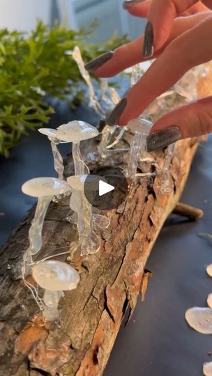 a person is cutting glass pieces on a piece of wood with an object in the foreground