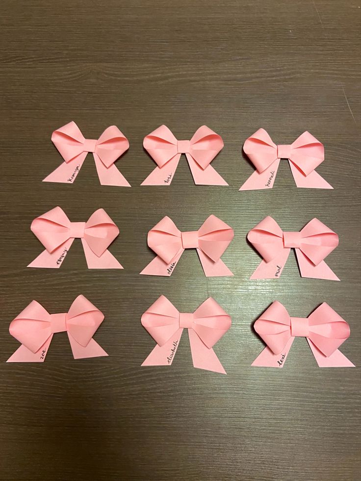 several pink bows laid out on a table