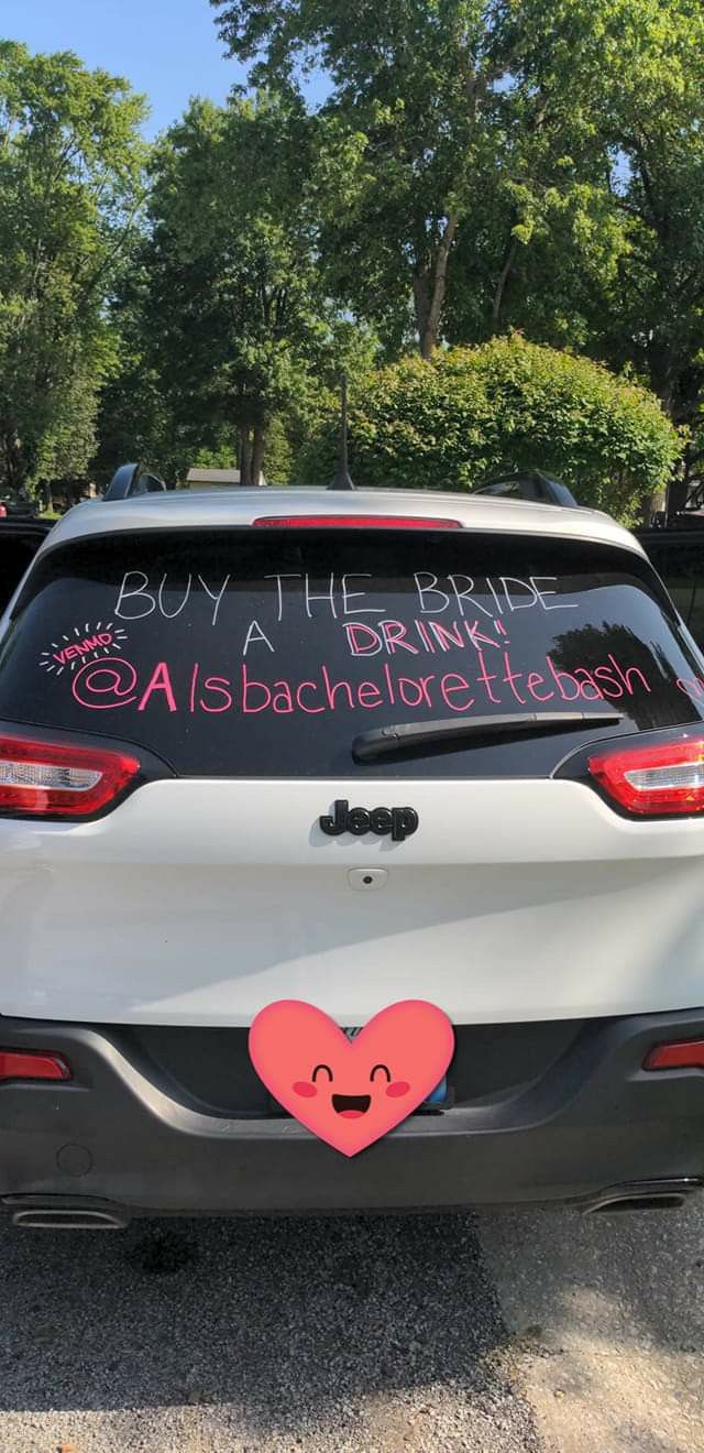 a car that has been decorated with pink hearts and writing on the rear window says, don't drink