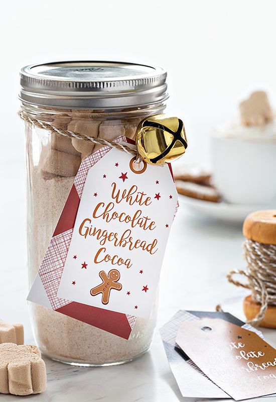 a glass jar filled with cookies next to some tags and other items on a table