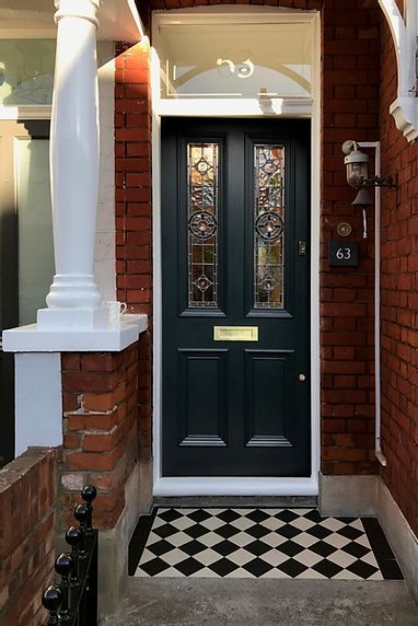 a black and white checkerboard floor in front of a door