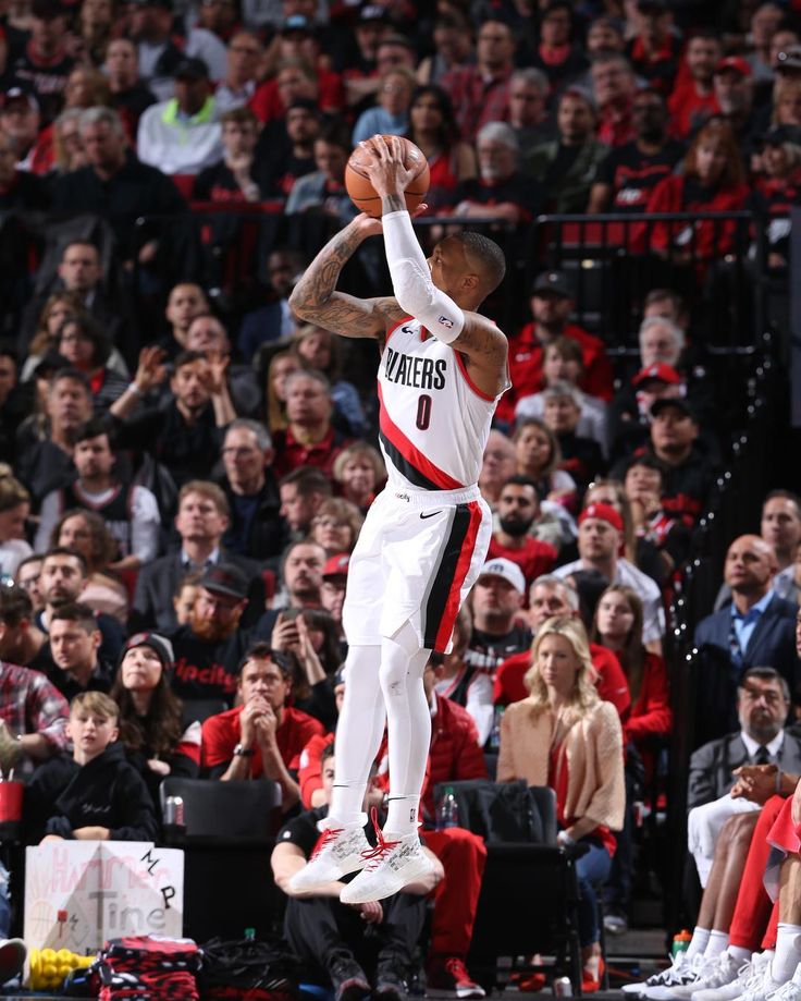 the basketball player is jumping in the air to dunk