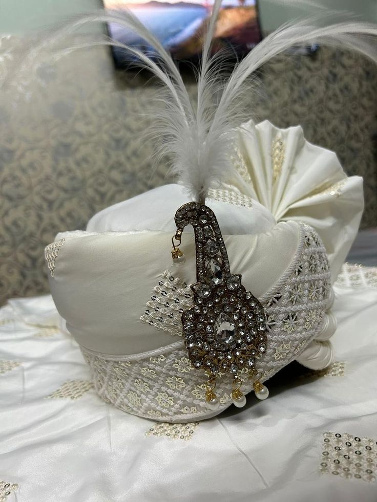 a white hat with feathers on top of it