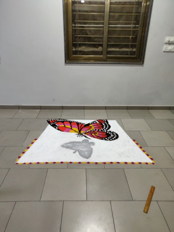 a butterfly rug on the floor in front of a window