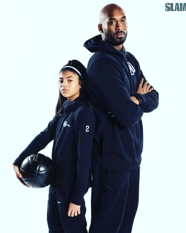 a man and woman in black sports wear posing for the camera with their arms crossed