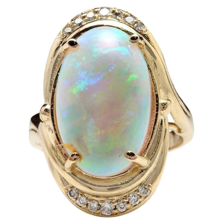 5.35 Carats Natural Impressive Ethiopian Opal and Diamond 14K Solid Yellow Gold Ring The opal has beautiful fire, pictures don't show the whole beauty of the opal! Total Natural Opal Weight is: 5.00 Carats Opal Measures: 17.88x 11.20mm Total Natural Round Diamonds Weight: .35 Carats (color G / Clarity VS2-SI1) Ring size: 7 (we offer free re-sizing upon request) Ring total weight: 9.3 grams Disclaimer: all weights, measurements and colors are approximate and may vary slightly from the listed dime Opal Diamond Engagement Ring, Fire Pictures, Yellow Gold Cocktail Ring, Fire Opal Ring, Gold Statement Ring, Gold Cocktail Ring, Yellow Gold Engagement Rings, Pretty Rings, Yellow Gold Ring